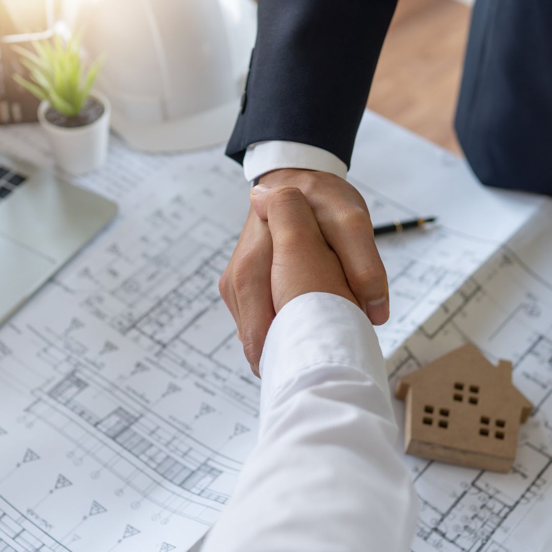 Shaking hands after discussing house plans